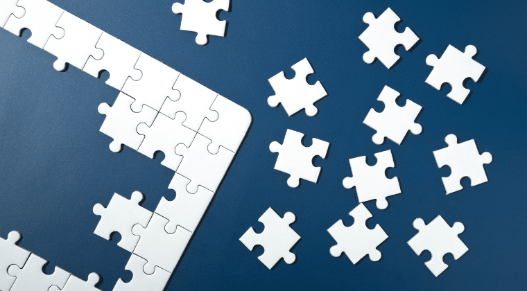 Jigsaw Puzzle And parts laying on a blue background. Understanding the Bible as A Whole Church Equip Curriculum