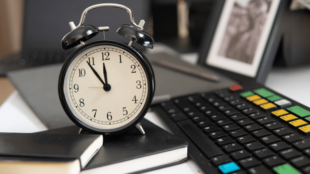 clock on top of notebooks with a computer keyboard. Consulting office hours