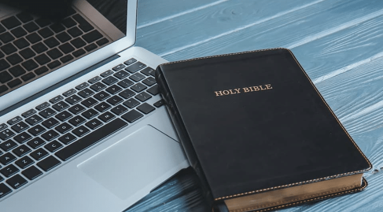 Bible laying on top of corner of laptop. Church Equip. Clear and Concise Guide to Christian Beliefs Church Equip Curriculum